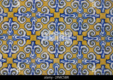 Beautiful ornament on ceramic vintage tiles in blue and yellow tones. Spanish style ceramic tiles Stock Photo