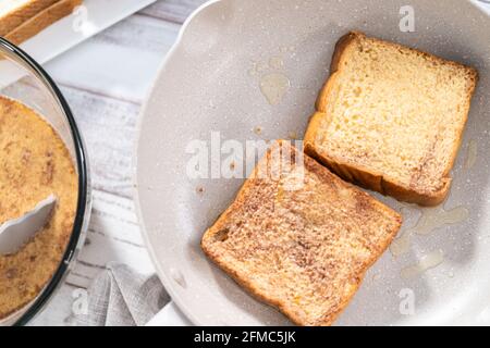 Frying french toast in a nonstick frying pan. Stock Photo