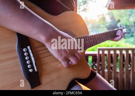 Female musician playing classical guitar Stock Photo