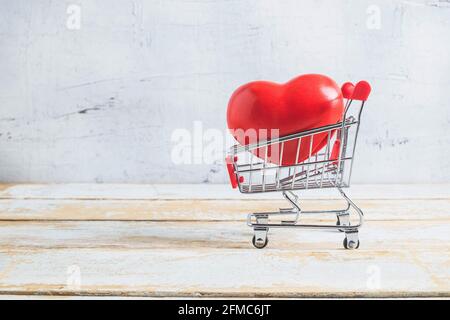 Red heart  in shopping cart.Valentines Day concept Stock Photo
