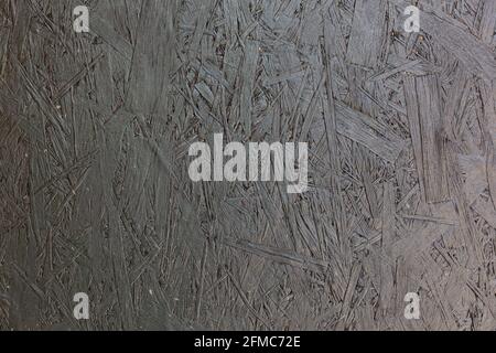dark gray painted OSB - Oriented strand board - board surface full frame background and texture Stock Photo