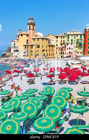 Camogli, Genoa, Italy - July 3, 2019:  Beach with parasols and sunbathing people in Camogli, Genova Stock Photo