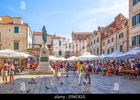 Dubrovnik, Croatia - Jine 12, 2017: Old square with walking people in Dubrovnik. Cityscape Stock Photo