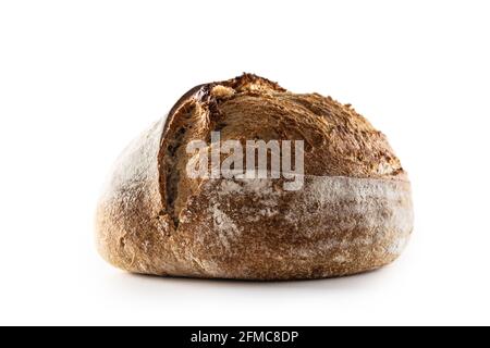 Isolated freshly baked crunchy yeast bread loaf lying on the table. Stock Photo