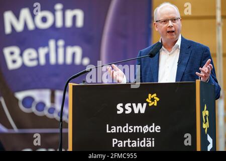 Schleswig, Germany. 08th May, 2021. Stefan Seidler (SSW, 41), candidate for list position 1 of his party, speaks during the extraordinary state party conference for the top candidacy for the Bundestag election at the A. P. Moeller School. Credit: Axel Heimken/dpa/Alamy Live News Stock Photo