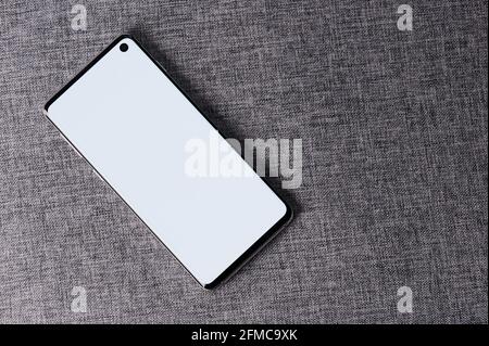 Modern smartphone on fabric background above top view Stock Photo