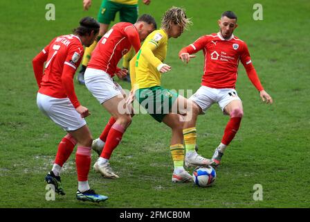 Barnsley's Jasper Moon (second left), Callum Brittain (left) and Conor Chaplin battle for the ball with Norwich City's Todd Cantwell during the Sky Bet Championship match at Oakwell Stadium, Barnsley. Picture date: Saturday May 8, 2021. Stock Photo