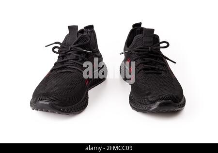 New black mesh lace-up sneakers isolated on white background. Pair of modern breathable shoes for hot summer. Comfortable men shoes for fitness, sport Stock Photo