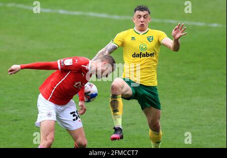 Norwich City's Jordan Hugill (right) and Barnsley's Michal Helik battle for the ball during the Sky Bet Championship match at Oakwell Stadium, Barnsley. Picture date: Saturday May 8, 2021. Stock Photo