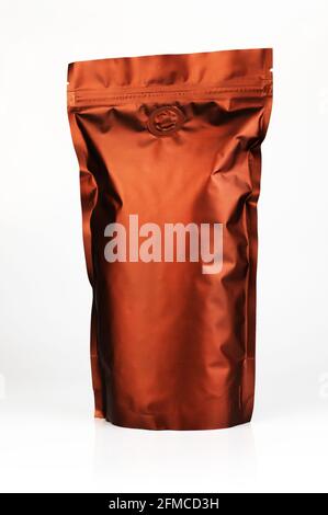 Vacuum packaging of coffee isolated on white background. Coffee pack mockup with place for text. Brown zippo bag for storing grains and food. Isolate closeup pack. Stock Photo