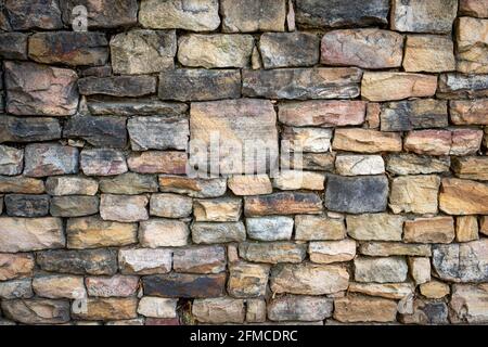 Stacked stone wall with interesting color and texture Stock Photo
