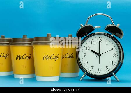 Morning red alarm clock and disposable paper cup or mug isolated on white with clipping path Stock Photo