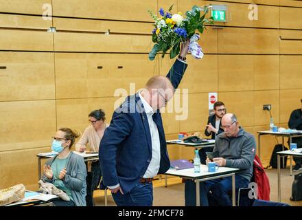 Schleswig, Germany. 08th May, 2021. Stefan Seidler, candidate for list position 1 of the Südschleswigscher Wählerverband (SSW), celebrates his election during an extraordinary state party conference for the top candidacy for the Bundestag election at the A. P. Moeller School. Credit: Axel Heimken/dpa/Alamy Live News Stock Photo