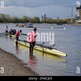 Putney, Greater London, England - May 04 2021: Youngsters in rowing boats on the River Thames prior to a training session. Stock Photo