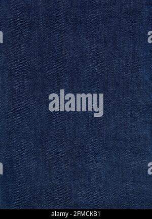 A flat area of dark blue denim fabric as a background texture and pattern Stock Photo