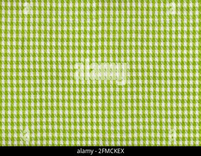 A flat area of woven fabric as a background texture and pattern green and white gingham Stock Photo
