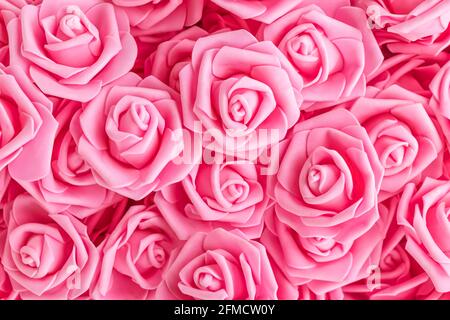 background of pink flowers. Artificial pink roses, foamiran roses. fake flowers. soft focus Stock Photo
