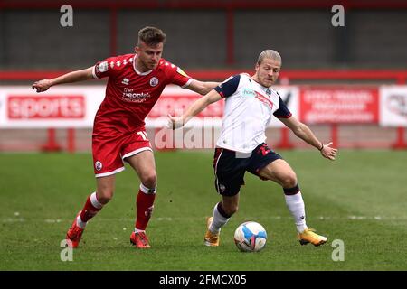 Bolton Wanderers' Lloyd Isgrove and Crawley Town’s Jordan Tunnicliffe (left) battle for the ball during the Sky Bet League Two match at The People's Pension Stadium, Crawley. Picture date: Saturday May 8, 2021. Stock Photo