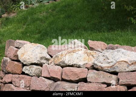 Background stone wall made of red stones Stock Photo