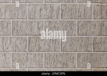 artificial brick-like pattern embossed in flat plaster surface. Stock Photo