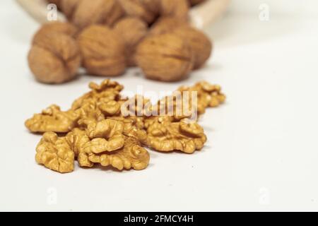 walnut kernels and whole nuts on a light background. Stock Photo