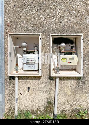 Two gas diahragm meters on exterior wall of building Stock Photo