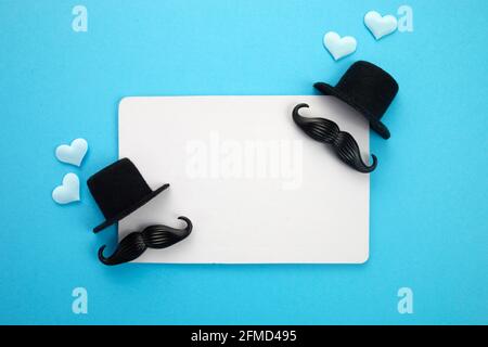 Happy Father's Day greeting card of white frame with decoration. Includes mustache, hat and hearts. Stock Photo