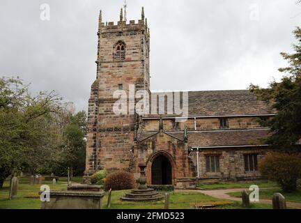 Parish Church of Saint Peter in Prestbury with a listed sandstone sundial in the graveyard Stock Photo