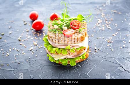 Traditional double sandwich on a dark textured background. School lunch, fast food. Stock Photo