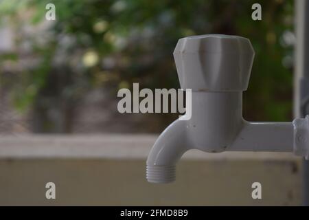 White water pipe with a faucet attached to a wall. water concept. Stock Photo