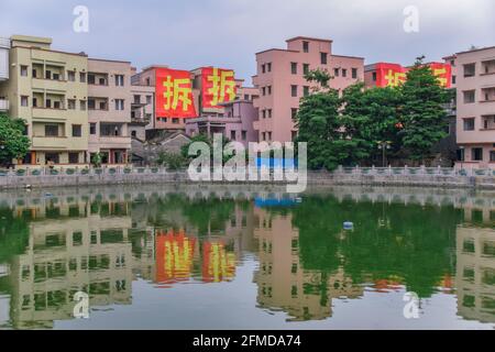 Guangzhou,China. MAY 1, 2021.   Buildings under demolition, partly pulled down and due to be replaced with new apartment blocks. Stock Photo