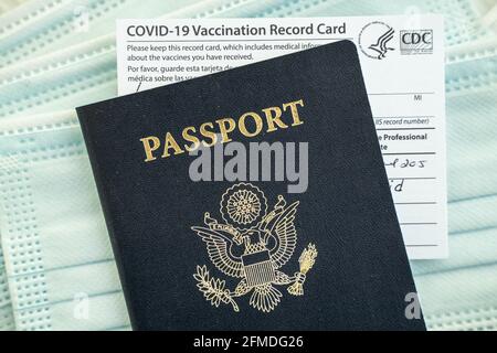 COVID-19 Vaccination Record card and US Passport Stock Photo