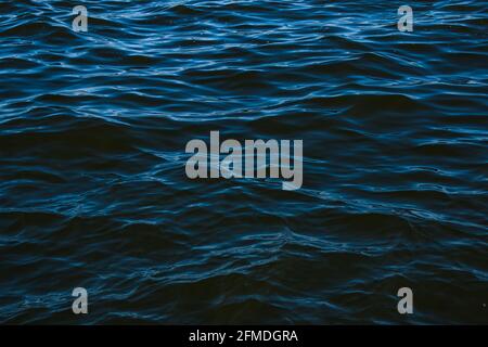 Abstract background of river water flow under the influence of light. The surface of the Dnieper river in good weather. Stock Photo