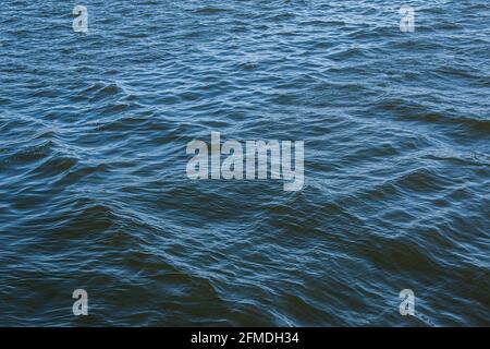 Abstract background of river water flow under the influence of light. The surface of the Dnieper river in good weather. Stock Photo