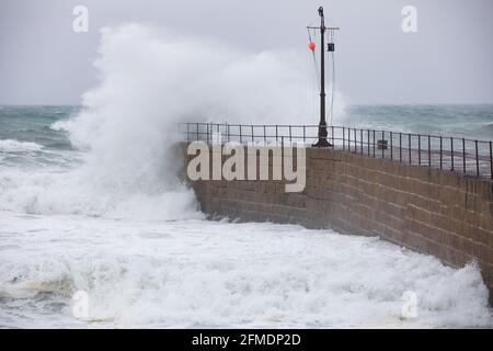 Porthleven,Cornwall,8th May 2021,Rough seas crash over the harbour wallcaused by the extremely strong winds in Porthleven, Cornwall. The Temperature was 12C, the forecast is for rain & strong winds over the next few days.Credit: Keith Larby/Alamy Live News Stock Photo