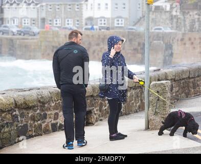 Porthleven,Cornwall,8th May 2021,People were out walking their dog despite the extremely strong winds in Porthleven, Cornwall. The Temperature was 12C and the forecast is for rain & strong winds over the next few days.Credit: Keith Larby/Alamy Live News Stock Photo