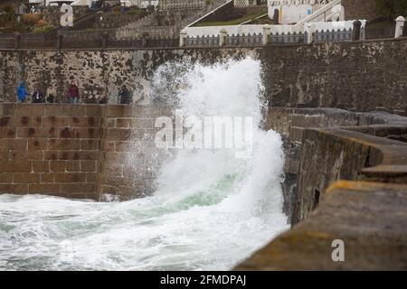 Porthleven,Cornwall,8th May 2021,Waves crash over the harbour wall  in Porthleven, Cornwall. The Temperature was 12C and the forecast is for rain & strong winds over the next few days.Credit: Keith Larby/Alamy Live News Stock Photo