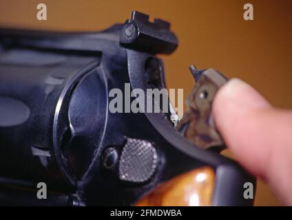 cocking the hammer on a smith and wesson 357 magnum handgun revolver Stock Photo