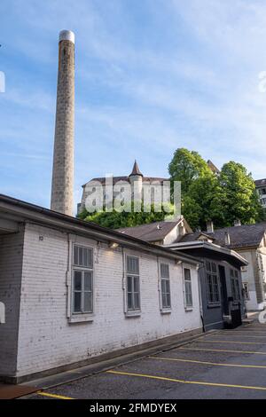 The chimney and the building of the old factory in Burgdorf, and in the background on the hill you can see the ca Stock Photo