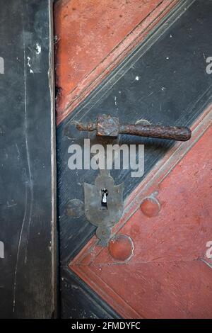 Burgdorf, Switzerland - May 9, 2020: A medieval hook on a black-and-red painted castle door. Stock Photo