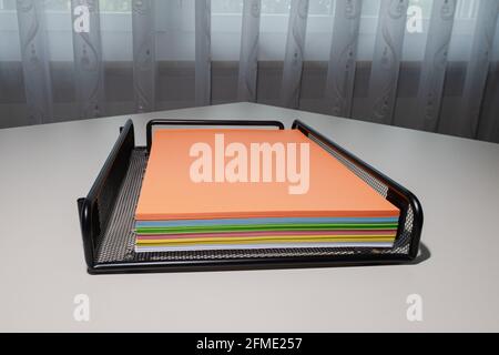 Zurich, Switzerland - June 13, 2020: The drawer with a pile of multicolored photocopy paper. Stock Photo