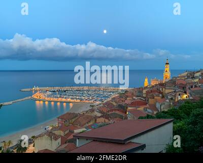 Menton, France - July 4, 2020: The evening descends to the Mediterranean tourist town of Menton on the French Riviera next ot Italian border.