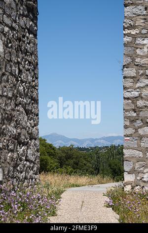 Sisteron, France - July 7, 2020: A paved walkway that leads between two stone walls Stock Photo