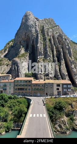 Sisteron, France - July 7, 2020: Sisteron is a town in Provence, situated on the banks of the River Durance and surrounded with steep cliffs. Stock Photo