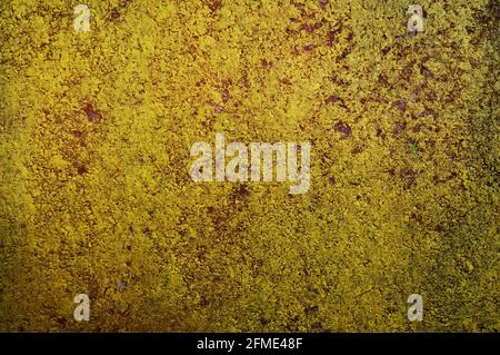Grunge concrete with damaged paint. This is a double exposure picture of a dirty red painted concrete wall and a yellow one Stock Photo
