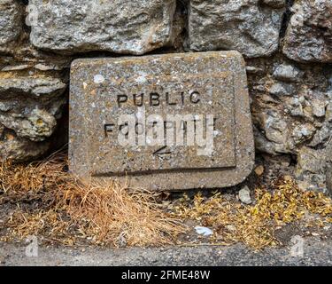 A stone block Public Footpath sign in the United Kingdom. Stock Photo