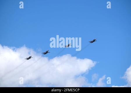 MOSCOW, RUSSIA - May 7, 2021: Group of Russian military tactical frontline bombers SU-24 fast flying in the blue sky on parade rehearsal in the sky Stock Photo