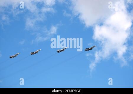MOSCOW, RUSSIA - May 7, 2021: Group of Russian military tactical frontline bombers SU-24 fast flying in the blue sky on parade rehearsal in the sky Stock Photo
