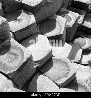 1950s, historical, a close-up view of the unique rock formations at the Giants Causeway, Antrim, Northern Ireland. These steps of hexagonal, interlocking basalt columuns were formed by the rapid cooling of volcanic lava upon contact with the sea and systematically uniform in shape, they are a remarkable natural wonder. Stock Photo
