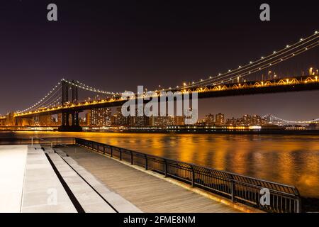 Manhattan Bridge from Brooklyn to Manhattan at night, with a viewing platform on Brooklyn side. Stock Photo